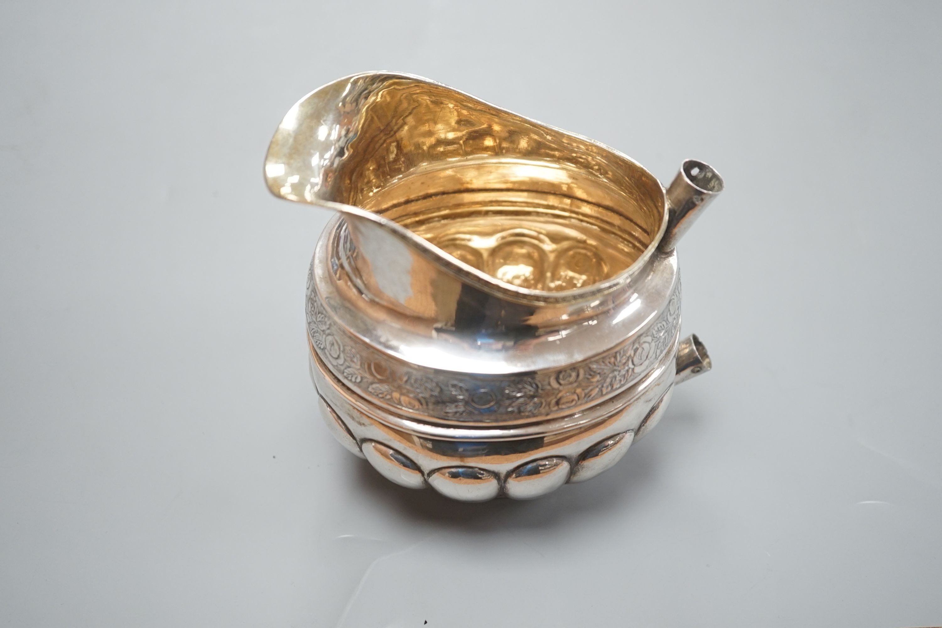 A 19th century Russian 84 zolotnik embossed cream jug, assay master, Michael Karpinsky, 1829, master, Fredrik Lonnqvist, with wooden handle (rivets missing), height 11.2cm, 6oz.